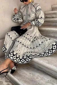 Elegant palace style long-sleeve geometric printed midi dress with belt on model