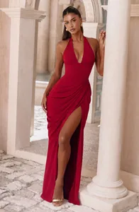 Elegant red halter neck maxi dress with a deep V-neck and high leg slit detail