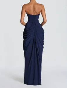 Back view of a navy blue strapless gown featuring elegant drapery and corset lacing.