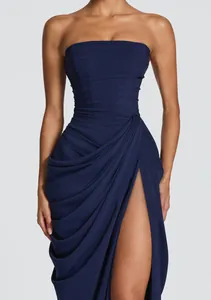 Navy blue strapless formal dress featuring asymmetrical pleated detail and high leg slit