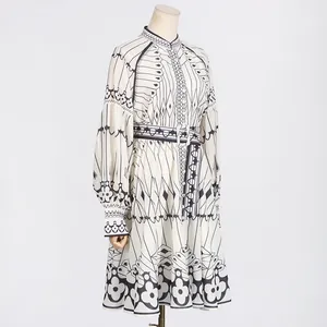 Close-up view of an elegant court style long-sleeved dress with geometric prints