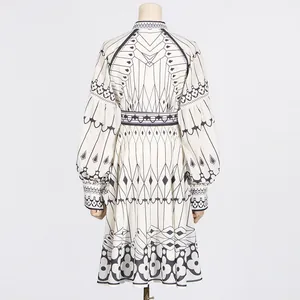 Back view of an elegant palace-style long sleeve midi dress with geometric floral print