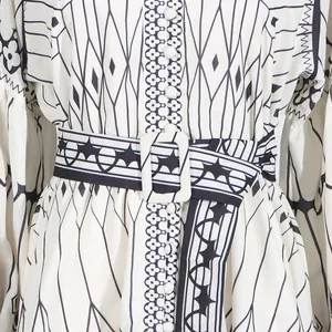 Close-up of elegant palace style printed dress with waist belt detail