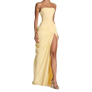 Elegant pale yellow strapless maxi dress with asymmetric pleats and high leg slit