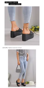 Detailed styling view of women's black platform wedge sandals with woven sole texture