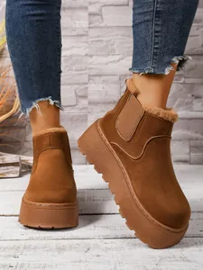 Detailed shot of women's brown platform snow boots with warm faux fur lining