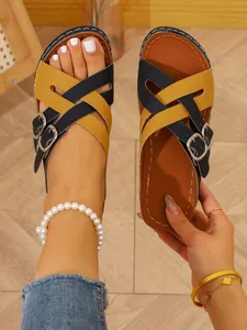 Detailed close-up showing the cross-strap design and buckle of color-block wedge sandals