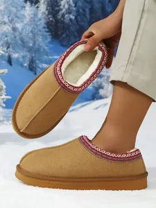 Detalle del forro de piel sintética blanca y adorno trenzado en zapatillas de invierno