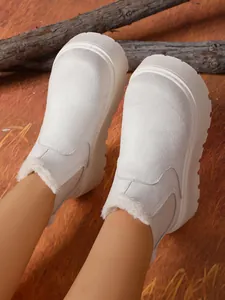 Detailed top view of white suede platform snow boots with warm faux fur lining