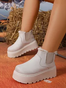 Detail view of women's beige suede platform snow boots with warm fur lining.