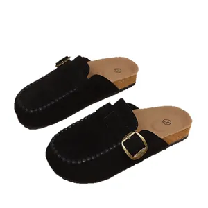 Classic black suede clogs with thick cork sole and adjustable gold buckle detail for women