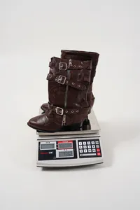 Detailed close-up of brown buckled mid-calf rider boots showing a total weight of 736g