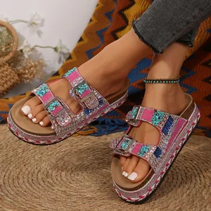 Bohemian platform sandals with rhinestone buckles and turquoise accents worn by a model.