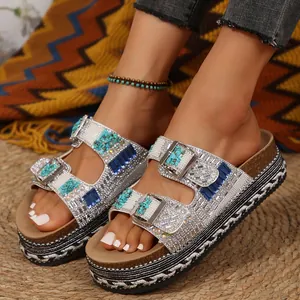 Detail view of platform slippers featuring sparkling rhinestones and blue turquoise stones