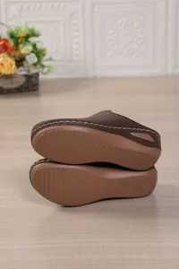 Bottom view of brown platform clogs showing anti-slip sole texture and size 37 mark