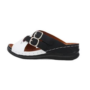 Women's wedge slide sandals with cross straps and buckle detailing in black and white