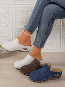 Detailed view showing women's platform mules in white, brown, and blue suede colors
