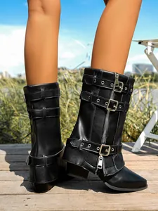 Detailed view of fashionable black western-style mid-calf boots with buckles and zippers.