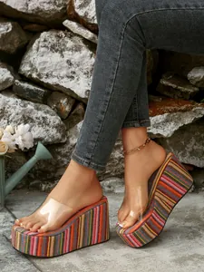 Detailed close-up of women's colorful striped platform wedge sandals with clear straps
