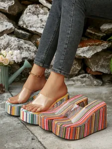 Close-up of colorful striped platform wedge sandals with transparent PVC straps