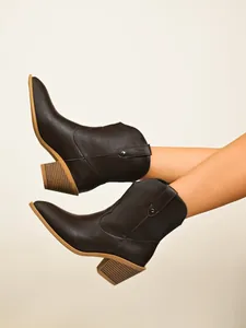 Side view of retro brown western ankle boots with pointed toe and chunky heel.