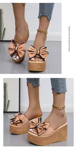 Detail view of peach platform sandals with a large decorative bow and cork-textured wedge sole.