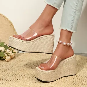 Detailed side view of transparent wedge sandals with thick straw woven platform soles.