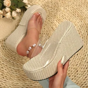 Detailed macro view of women's woven platform wedge slippers with clear PVC strap