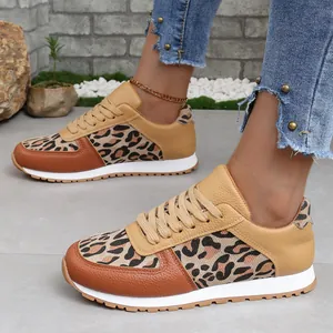 Stylish leopard print lace-up sneakers with tan faux leather accents for women.