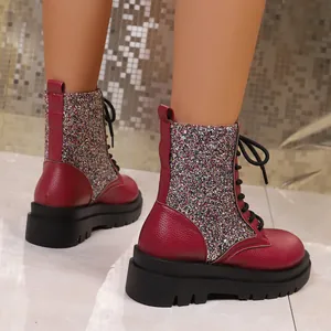 Macro detail of stylish wine red sequin platform lace-up boots with chunky soles for women.
