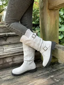 Side detail of women's suede slouchy mid-calf boots with buckles and knit collars