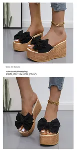 Detailed view of stylish black bow wedge platform sandals with woven jute sole texture