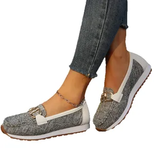 Stylish grey canvas loafers featuring a gold chain buckle and comfortable thick white sole