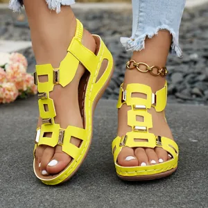 Stylish bright yellow peep toe wedge sandals featuring golden metal buckles and elastic back