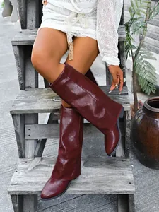 Detailed view of stylish burgundy pointed-toe sleeve boots with a chunky mid-heel