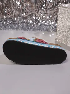 Detailopname van de rubberen zool en het blauwe touw op de strandsandalen strass