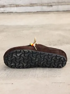 Detailed shot of dark brown suede clogs showing the durable anti-slip rubber sole.