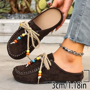 Detail view of brown suede platform mule showing 3cm heel height and colorful beads.