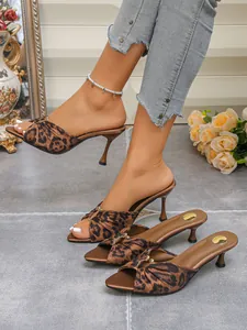 Elegant leopard print pointed toe mules with kitten heels and metal buckle detail