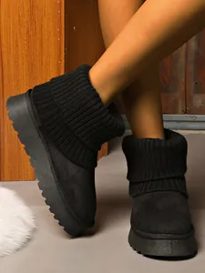 Detail view of black platform snow boots featuring warm knitted ribbed cuffs for women.