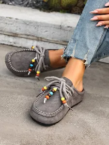 Grey women's suede mules with colorful beads and thick soles for casual autumn wear.