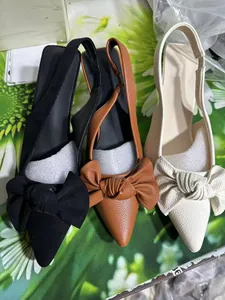 Detailed view of three colors of elegant bow slingback pumps in black brown and white
