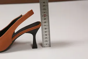 Detail of kitten heel height measurement for orange pebbled leather slingback pump