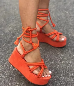 Close-up of orange rope lace-up platform wedge sandals for summer