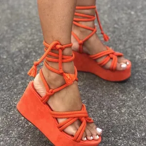 Vibrant orange lace-up wedge sandals with rope straps and platform peep-toe design