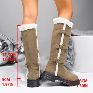 Detail of tan suede high-top snow boots featuring buckles, fur lining and measurements