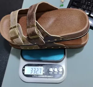 Weight measurement detail showing brown platform buckled sandals on a scale at 332.7g