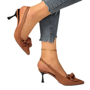 Elegant brown pointed-toe kitten heels with decorative bow and slingback strap.