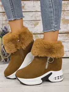 Close-up view of brown women's winter snow boots featuring warm fur trim and platform soles.