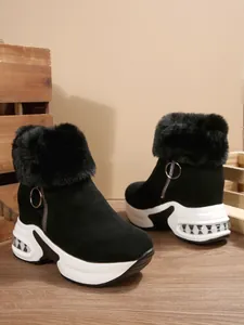 Side view of black platform snow boots featuring faux fur lining and stylish side zipper